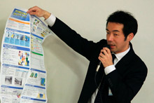 洪水ハザードマップを手に、丁寧に誌面の説明をする清水主査