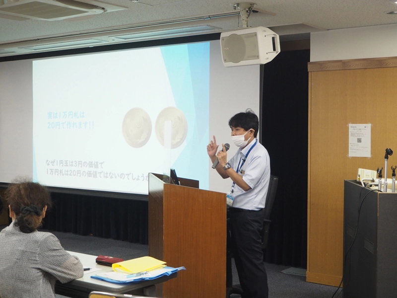お金の価値について説明する井上教授