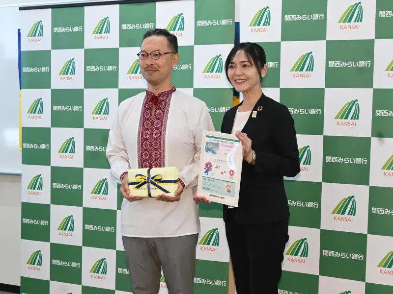 万博入場券を贈呈した関西みらい銀行の岩見佳奈子執行役員(右)と岡部芳彦名誉領事