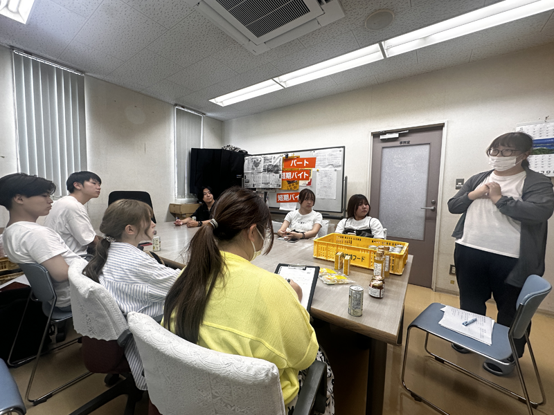 (株)神崎フードの担当者から説明を聞く学生ら